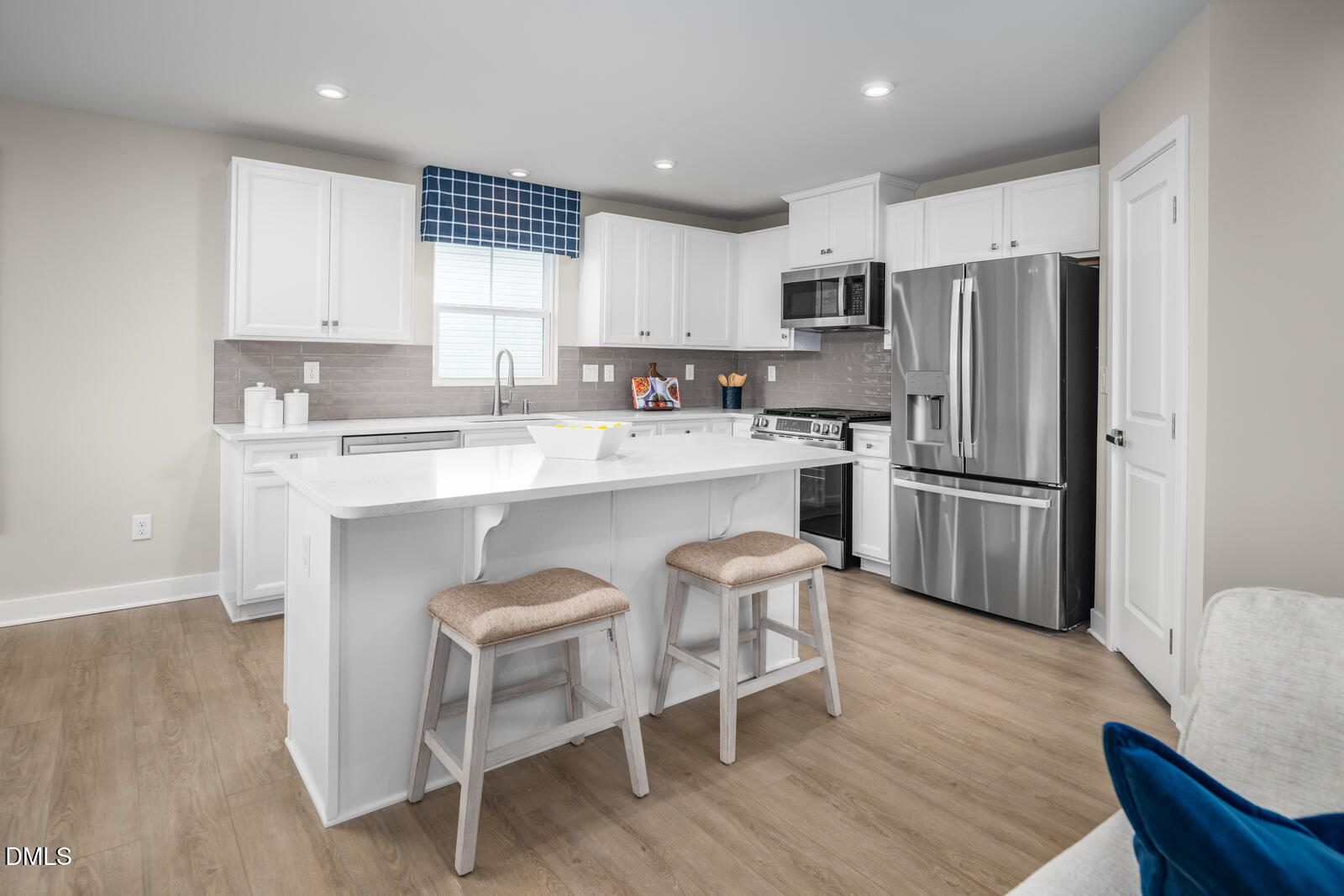 500 Country Side Way Fuquay-Varina, NC 27526 - Photo 5 of 22 a kitchen with stainless steel appliances a refrigerator a stove a sink and chairs