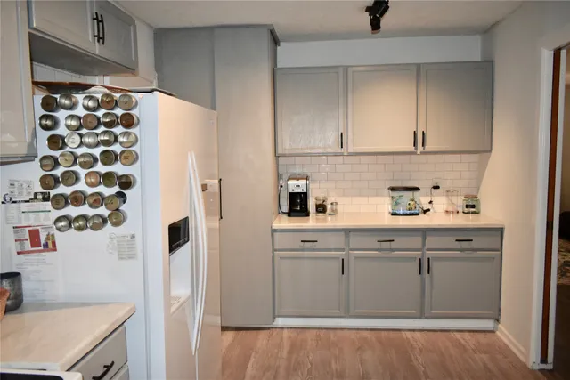a kitchen with stainless steel appliances a refrigerator and cabinets