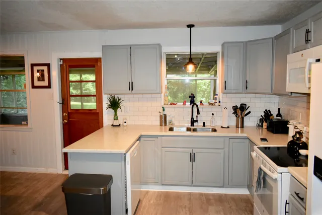 a kitchen with a sink a stove and cabinets