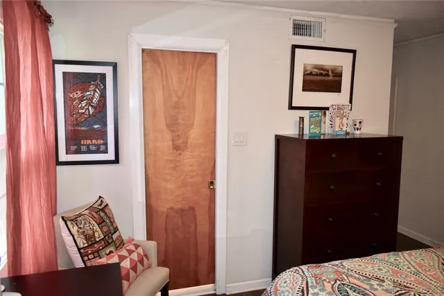 a bedroom with a bed and a mirror