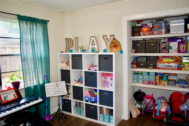 a room with lots of books and a large window