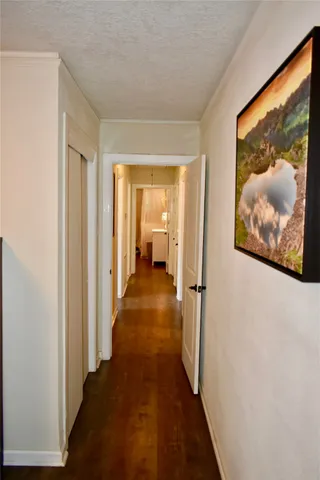 a view of a hallway with wooden shelves