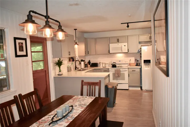 a kitchen with cabinets and wooden floor