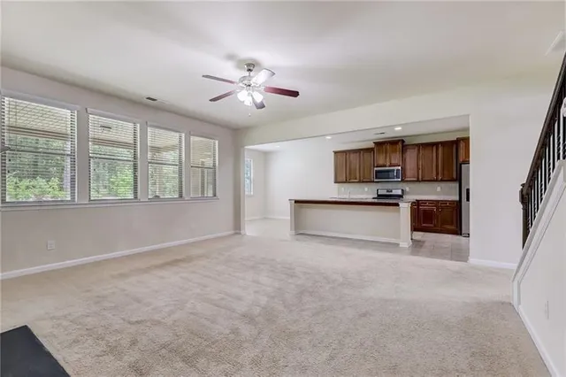 a kitchen with stainless steel appliances granite countertop a sink stove and cabinets