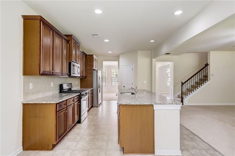 2680 Ogden Trail Buford, GA 30519 - Photo 15 of 45 a large kitchen with stainless steel appliances granite countertop a sink and cabinets