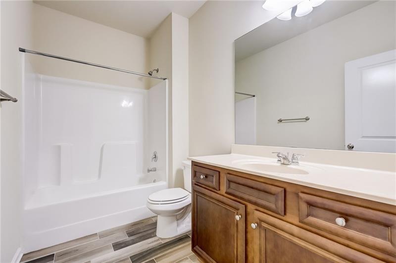 2680 Ogden Trail Buford, GA 30519 - Photo 17 of 45 a bathroom with a sink a toilet and shower