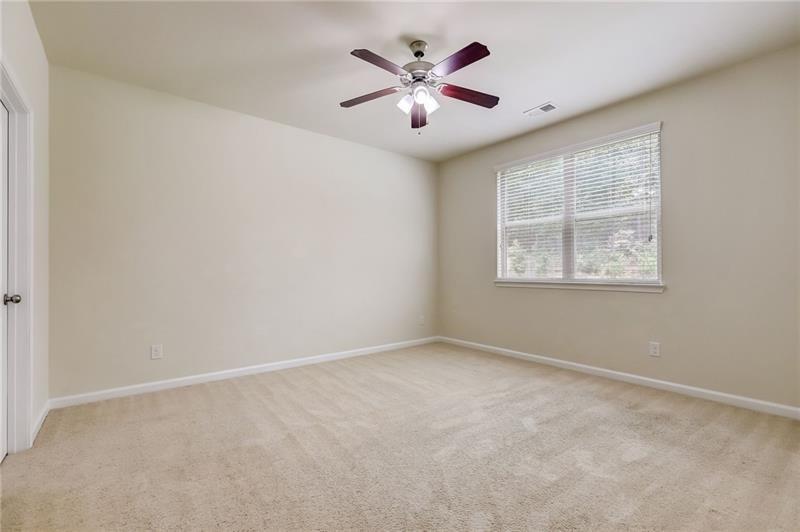 2680 Ogden Trail Buford, GA 30519 - Photo 18 of 45 an empty room with windows and fan