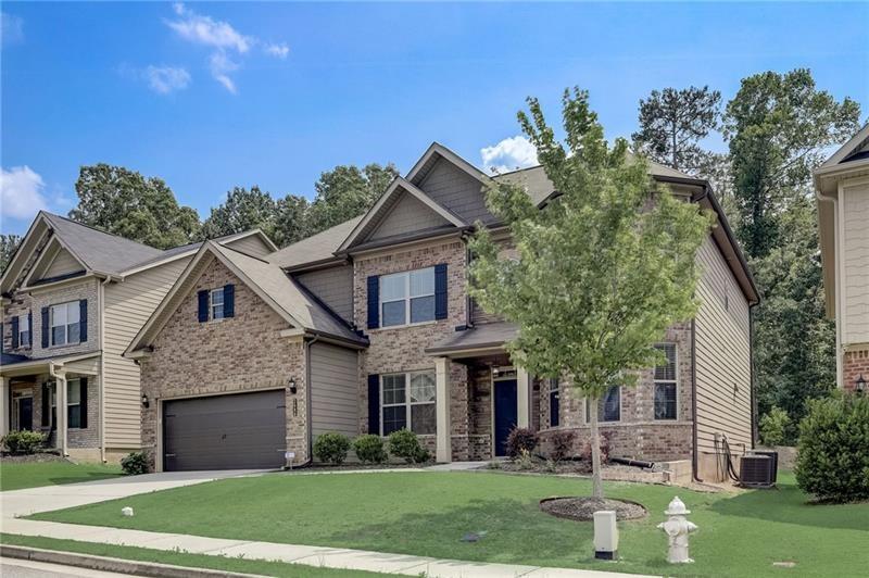 2680 Ogden Trail Buford, GA 30519 - Photo 2 of 45 a front view of a house with a yard and trees