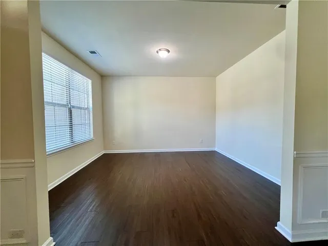 a view of a livingroom with a ceiling fan and window