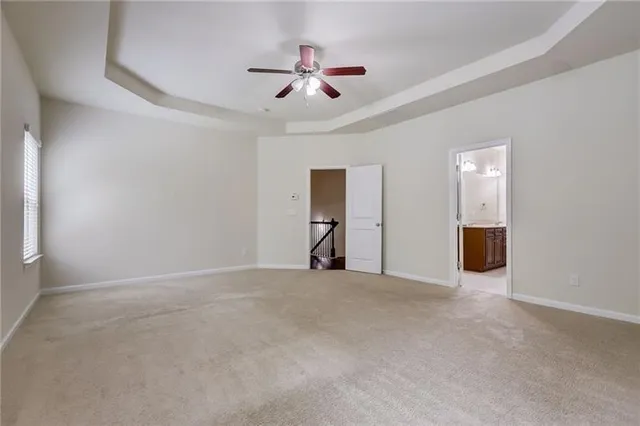 a spacious bathroom with a tub sink shower and mirror