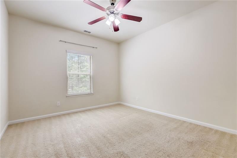 2680 Ogden Trail Buford, GA 30519 - Photo 29 of 45 an empty room with windows and fan