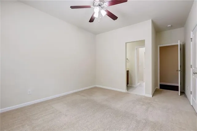 an empty room with chandelier fan