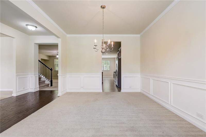 2680 Ogden Trail Buford, GA 30519 - Photo 4 of 45 a view of a hallway with wooden floor and chandelier