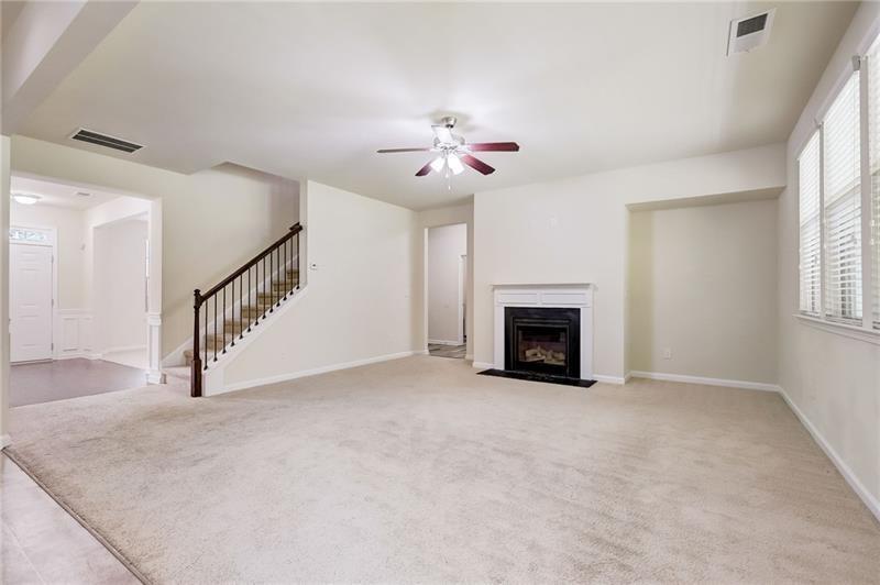 2680 Ogden Trail Buford, GA 30519 - Photo 9 of 45 a view of an empty room with chandelier fan and a fireplace