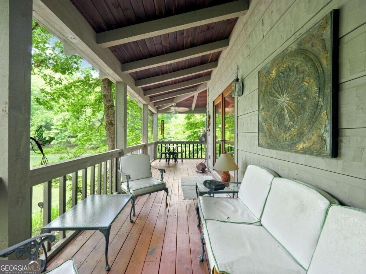 1402 Henderson Mountain Road Jasper, GA 30143 - Photo 12 of 76 a balcony with wooden floor