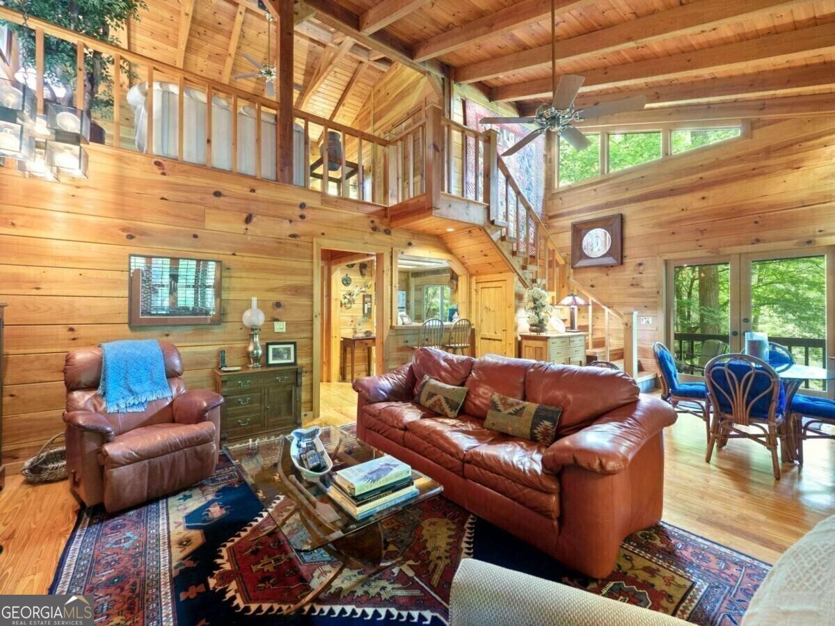 1402 Henderson Mountain Road Jasper, GA 30143 - Photo 23 of 76 a outdoor living space with patio furniture and a floor to ceiling window