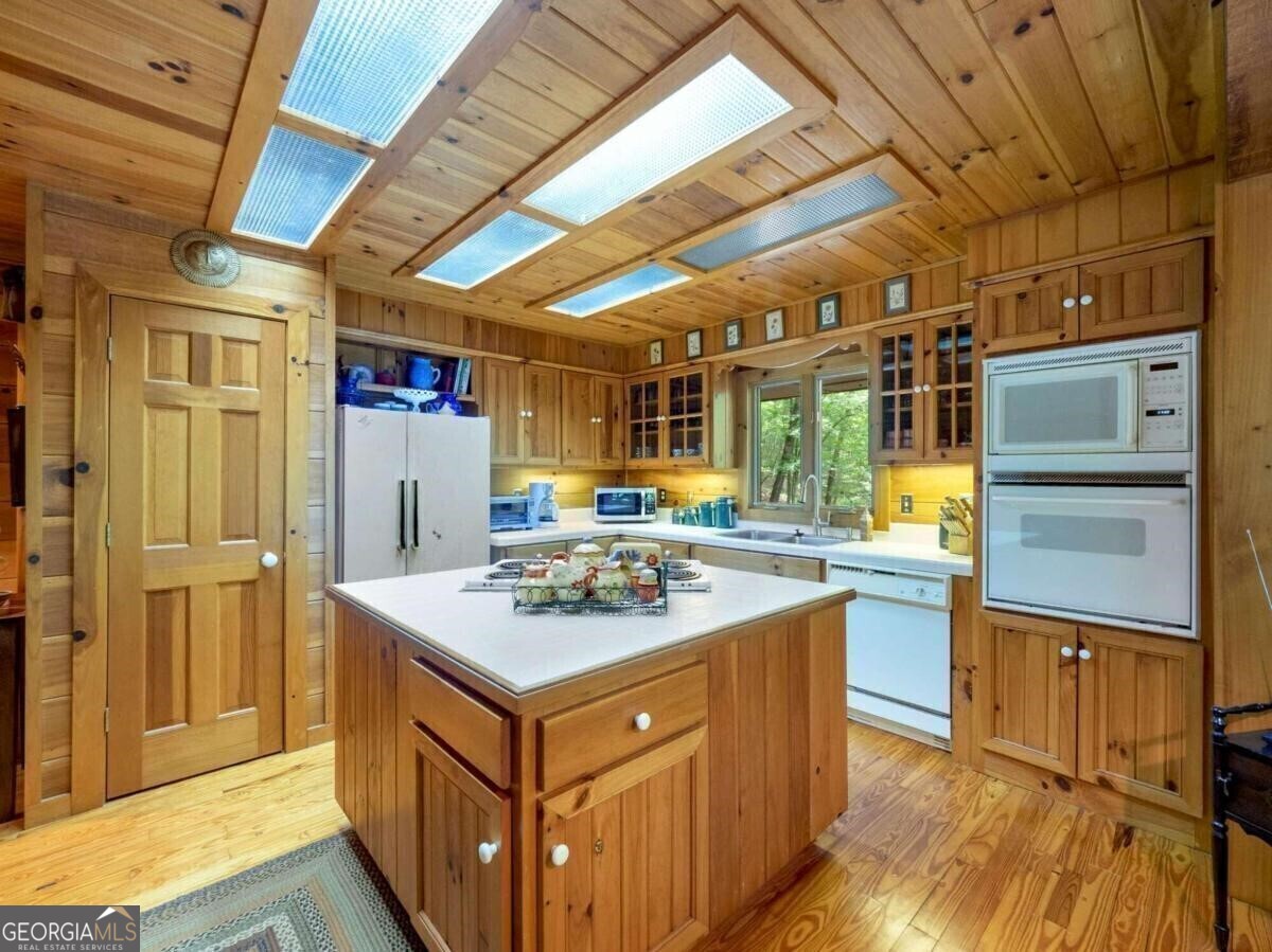 1402 Henderson Mountain Road Jasper, GA 30143 - Photo 32 of 76 a kitchen with a stove and a refrigerator