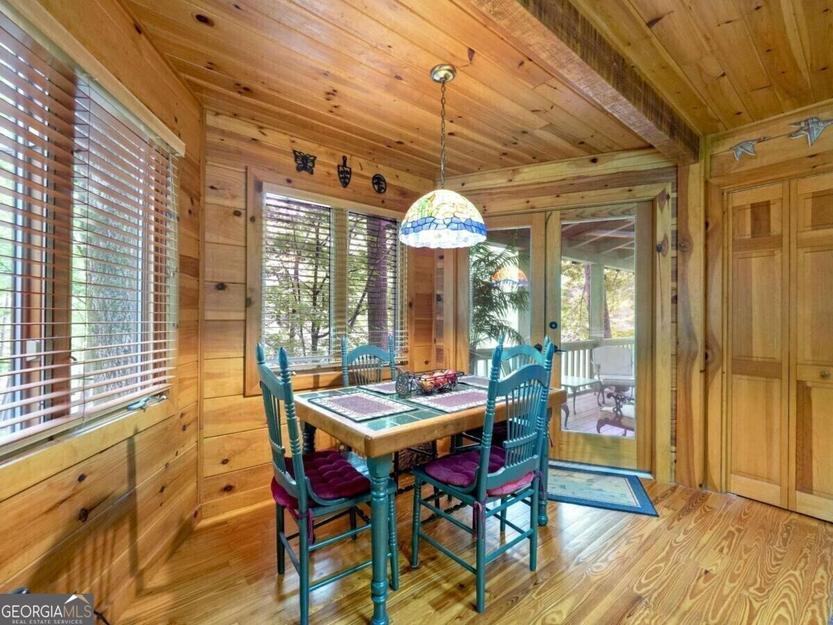1402 Henderson Mountain Road Jasper, GA 30143 - Photo 35 of 76 a outdoor dining space with furniture and wooden floor