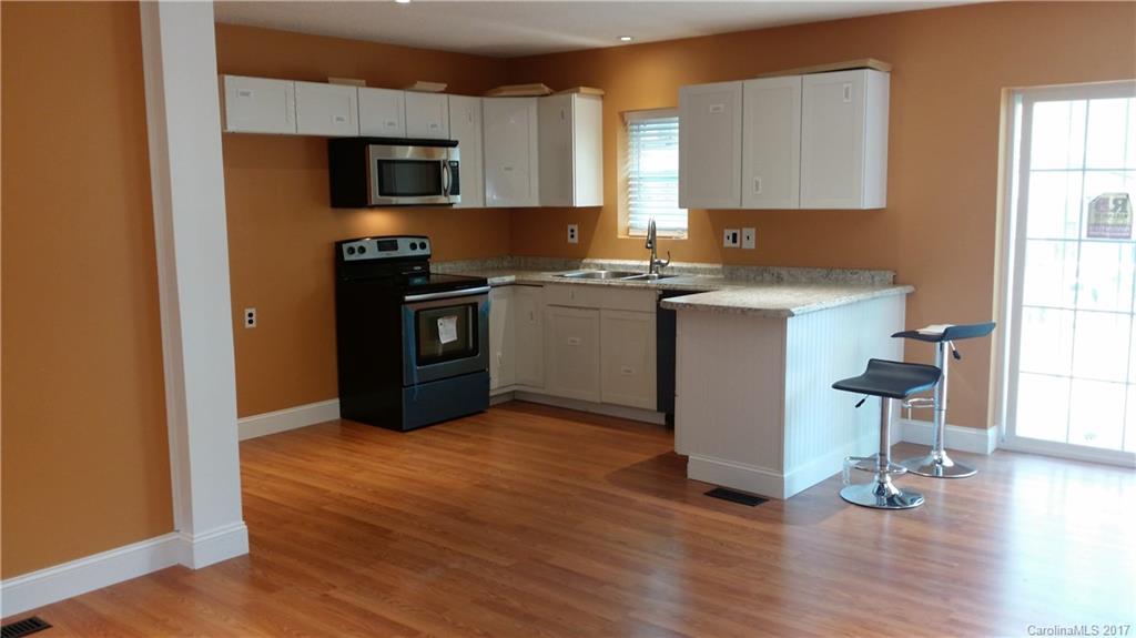 1929 State Rd S-29-584 Lancaster, SC 29720 - Photo 6 of 15 a kitchen with a refrigerator stove and wooden floor