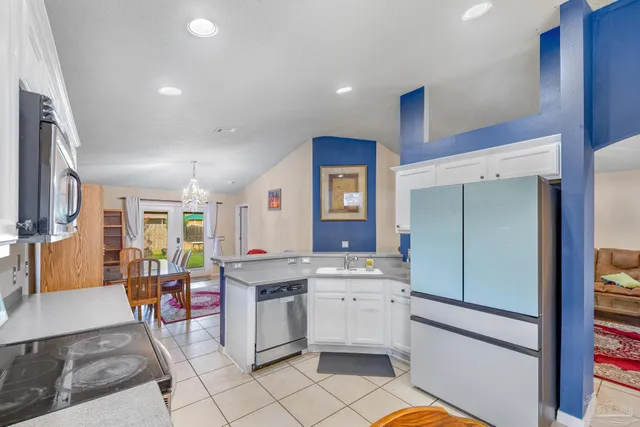 a kitchen with stainless steel appliances kitchen island granite countertop a sink and cabinets