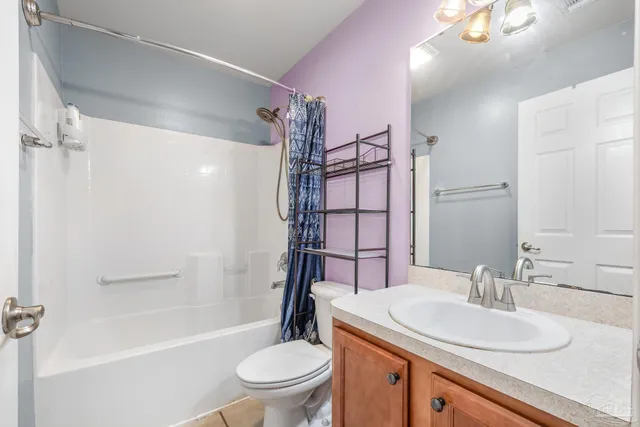 a bathroom with a sink toilet vanity and shower