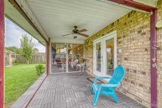 a view of a porch with chairs and backyard