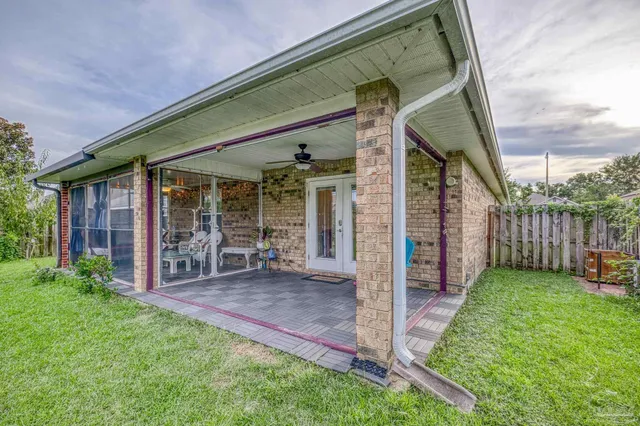 a view of a chair and table in backyard of the house