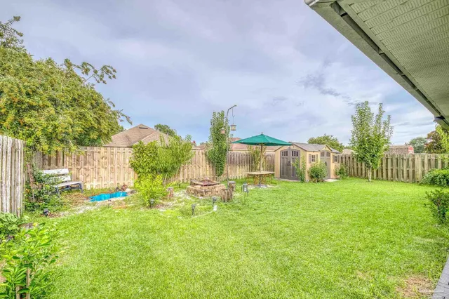 a view of an house with backyard space and garden