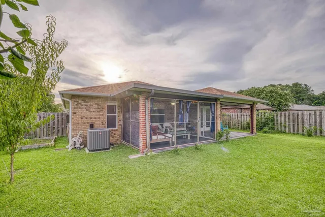 a view of a house with a yard and sitting area