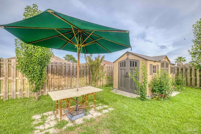 a view of a chair and table in the garden