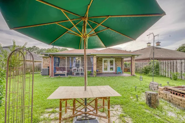 a view of a house with backyard and patio
