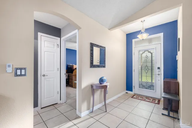 a view of a hallway to rooms and livingroom with furniture