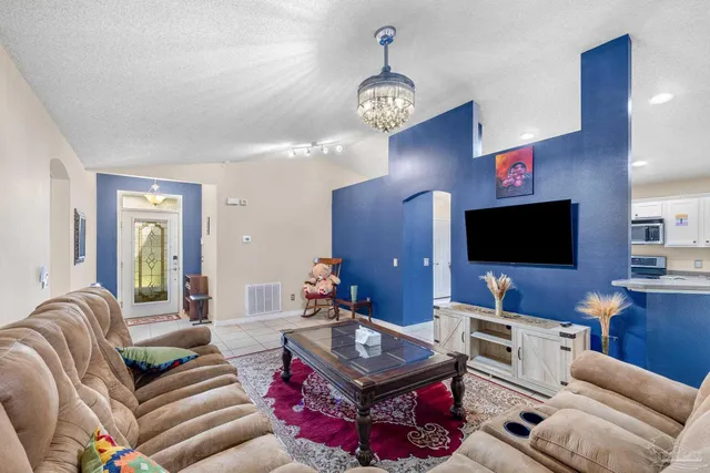 a living room with furniture and a flat screen tv
