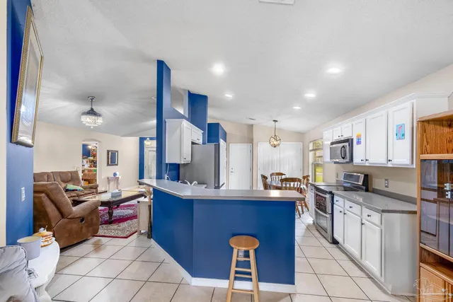 a kitchen with stainless steel appliances kitchen island granite countertop a sink counter space and cabinets