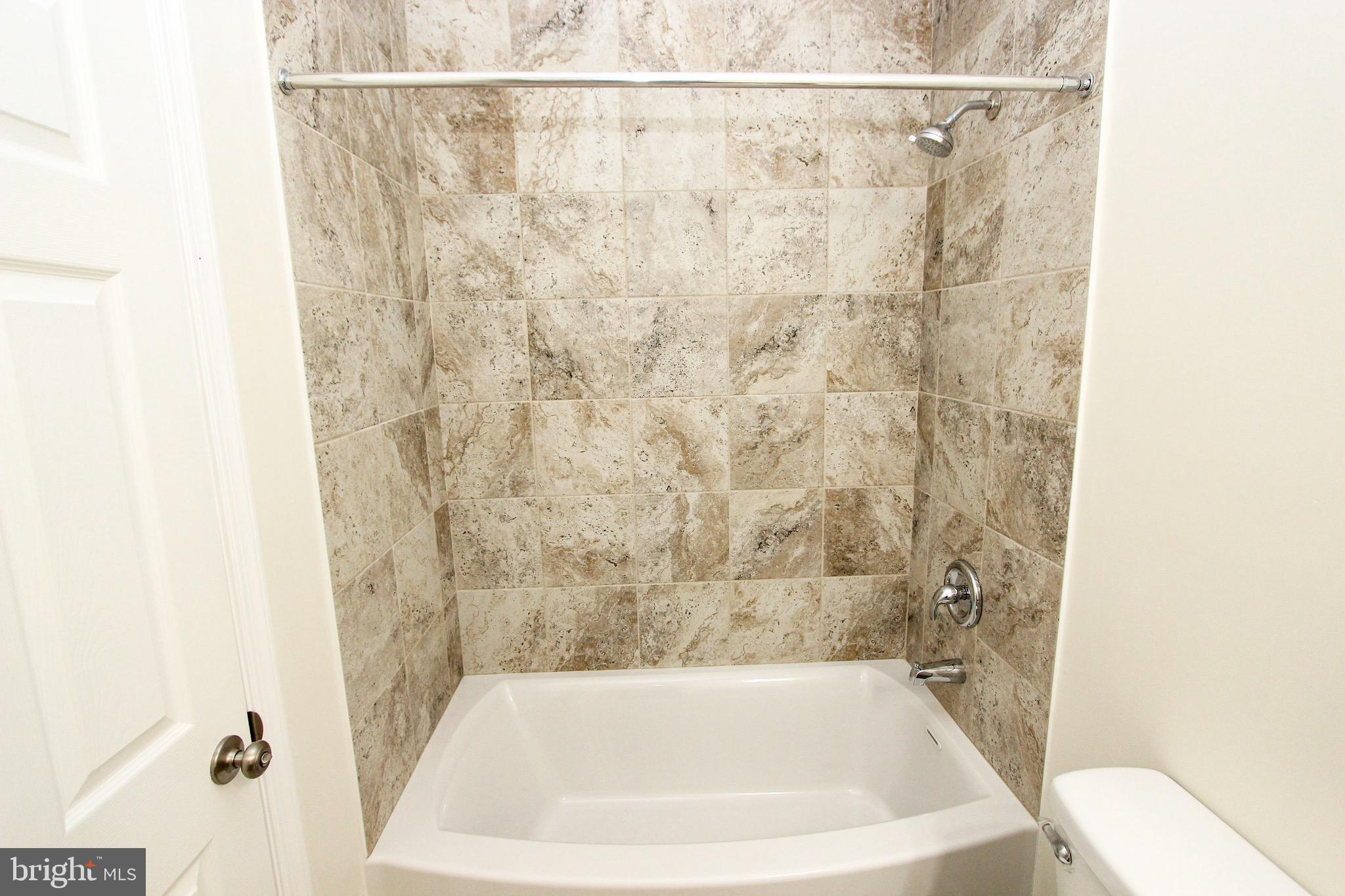 4 Whitetail Way Elkton, MD 21921 - Photo 23 of 28 a bathroom with a white bath tub and a shower curtain