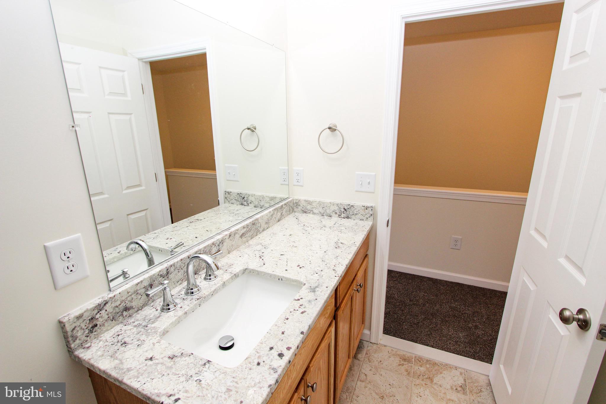 4 Whitetail Way Elkton, MD 21921 - Photo 24 of 28 a bathroom with a granite countertop sink and a mirror