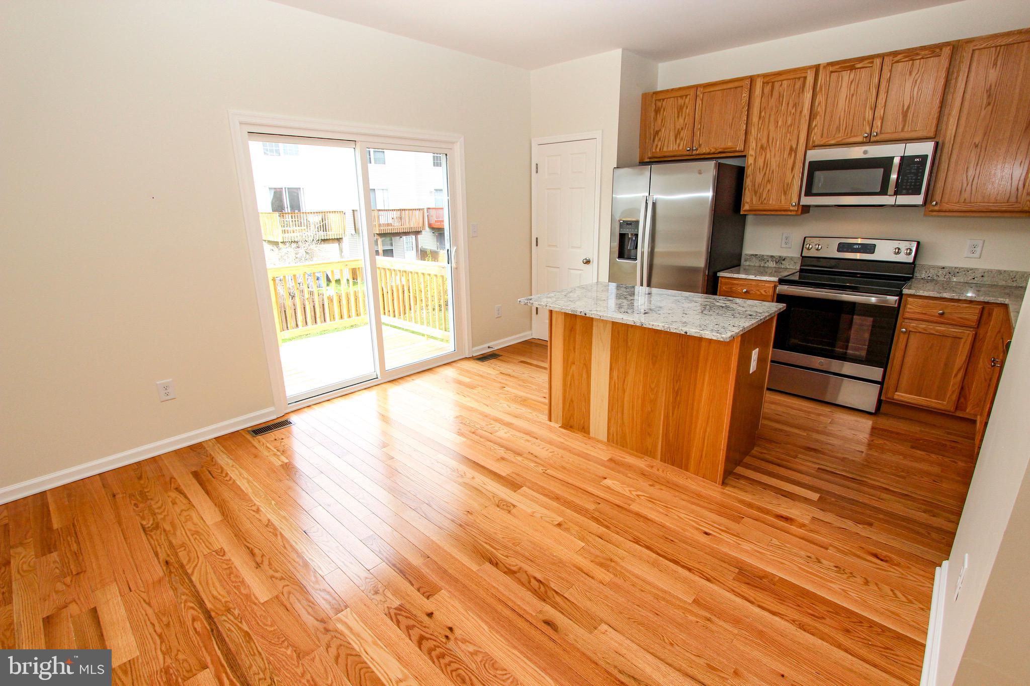4 Whitetail Way Elkton, MD 21921 - Photo 10 of 28 a kitchen with stainless steel appliances wooden floors and wooden cabinets