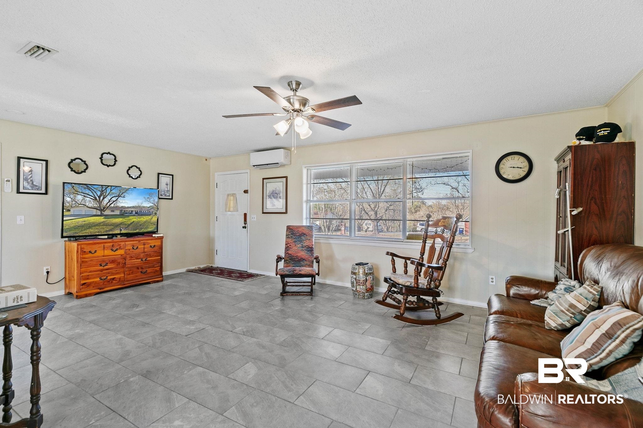 21267 Loop Road Andalusia, AL 36421 - Photo 17 of 72 Living area featuring ceiling fan and a wall unit AC
