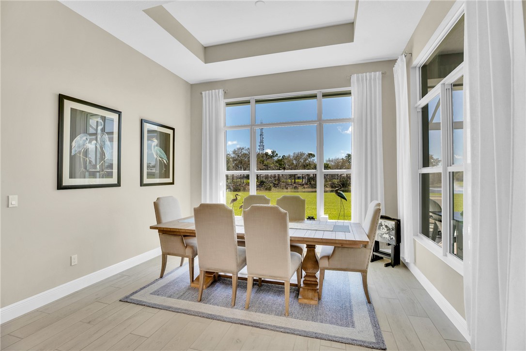 105 Night Hawk Way Sebastian, FL 32958 - Photo 14 of 36 a dining room with furniture a rug and wooden floor