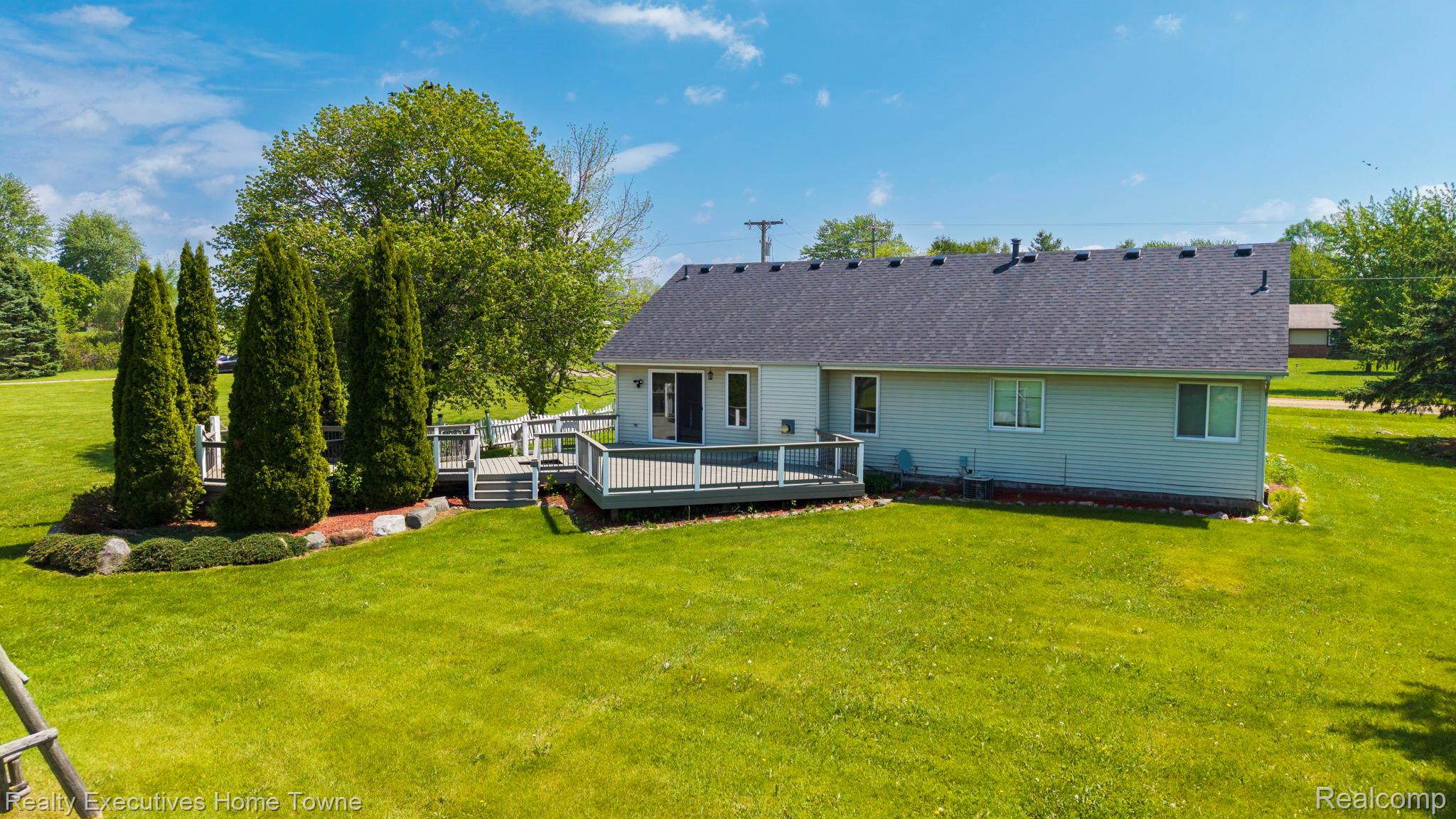 1041 Mackie Road Almont, MI 48003 - Photo 3 of 56 Back of property with a lawn and a deck