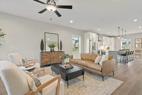 a living room with furniture and a chandelier