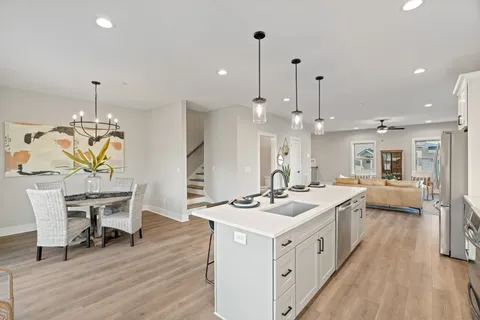 a kitchen with a table chairs and a white cabinets
