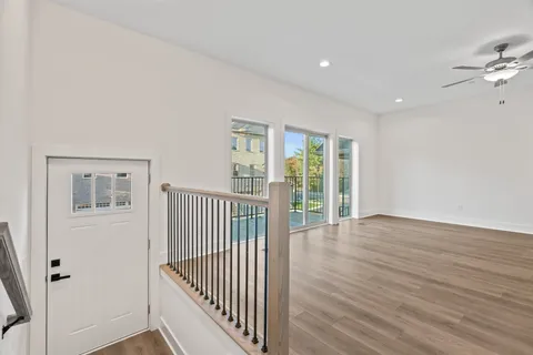 a view of a room with wooden floor and windows