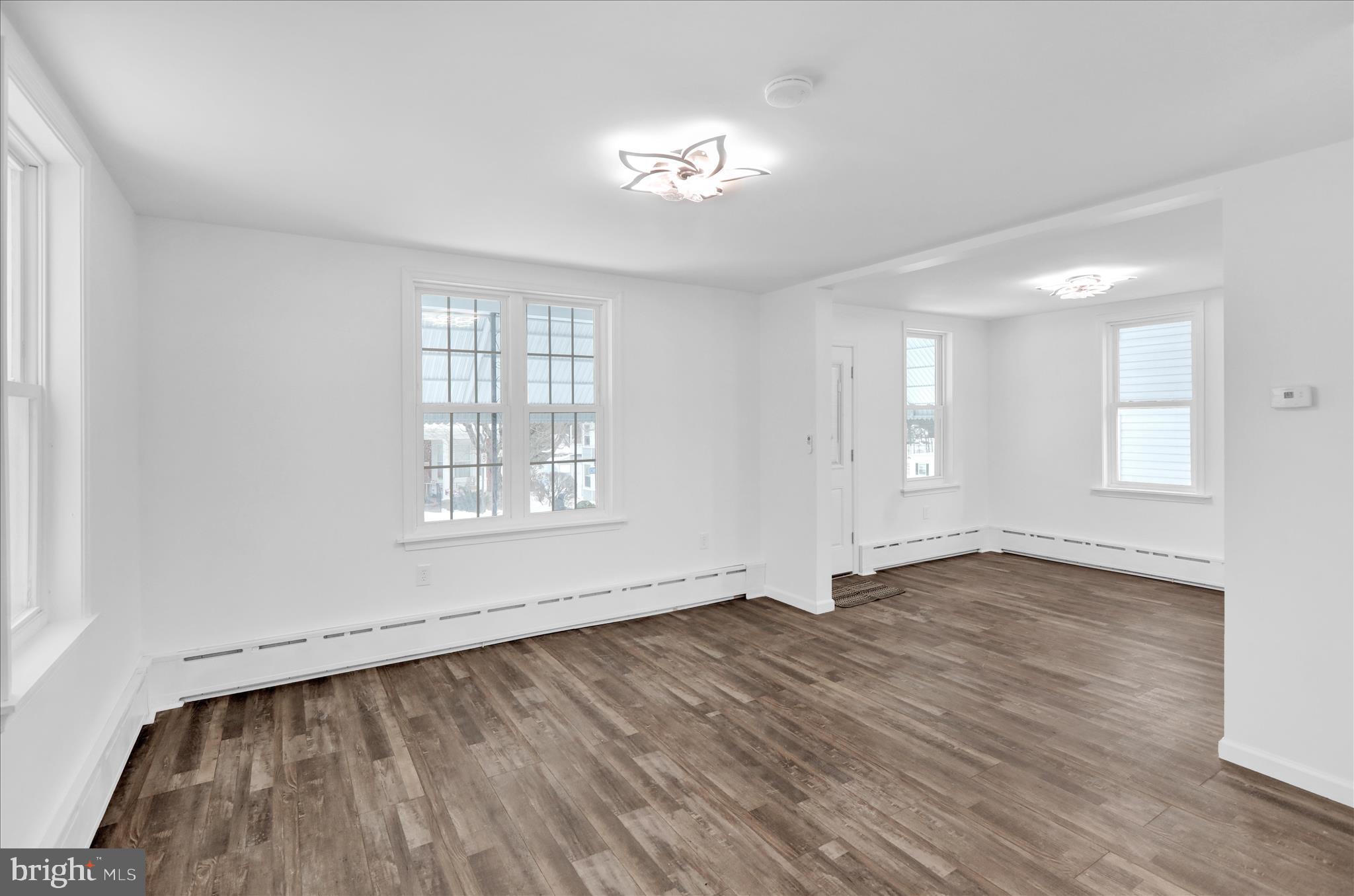 42 Chestnut Street Mohnton, PA 19540 - Photo 8 of 30 an empty room with wooden floor and windows