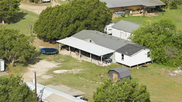 an aerial view of a house having yard