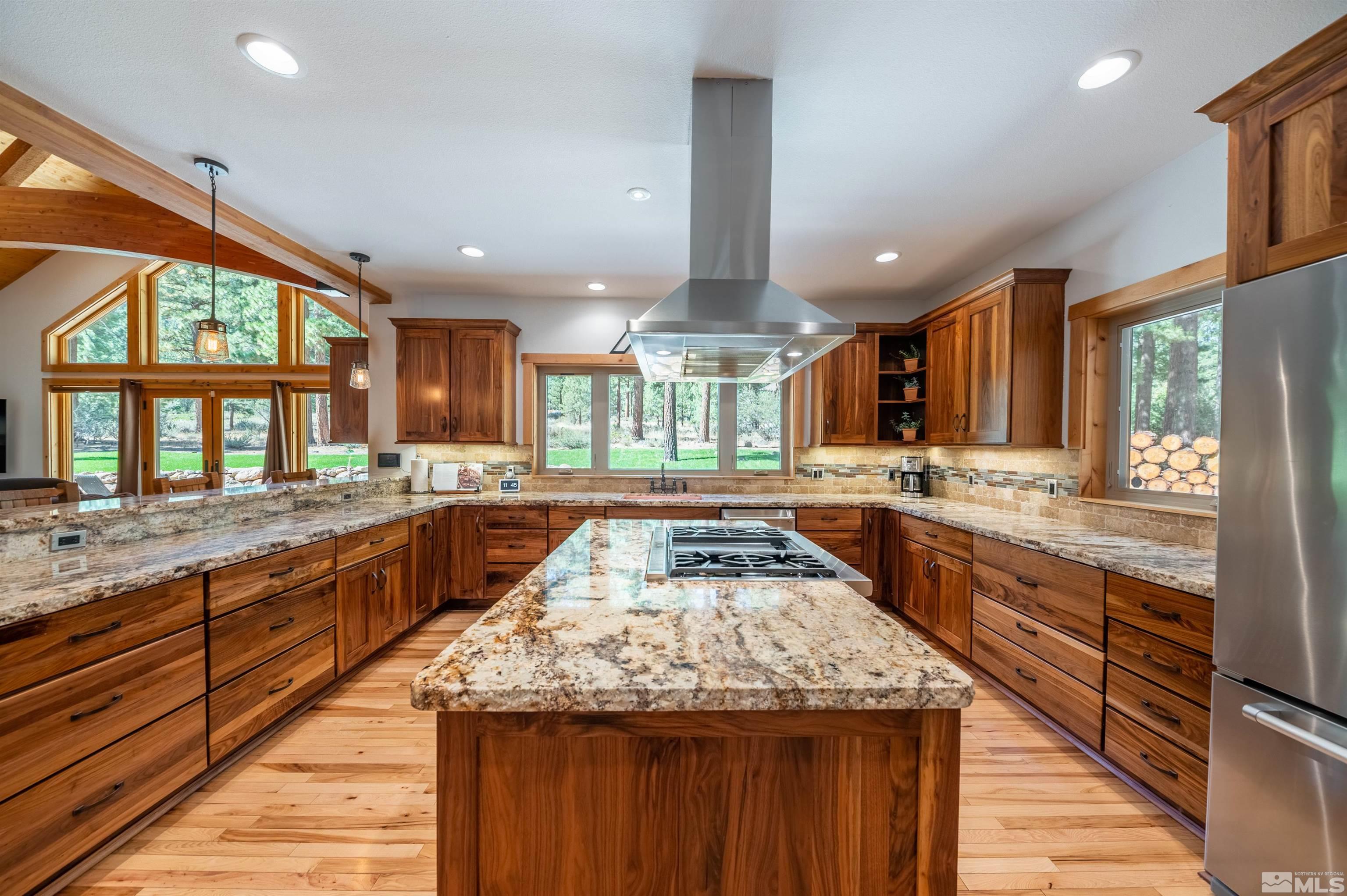 500 Yellow Pine Road Reno, NV 89511 - Photo 13 of 40 a kitchen with granite countertop kitchen island wooden cabinets and stainless steel appliances