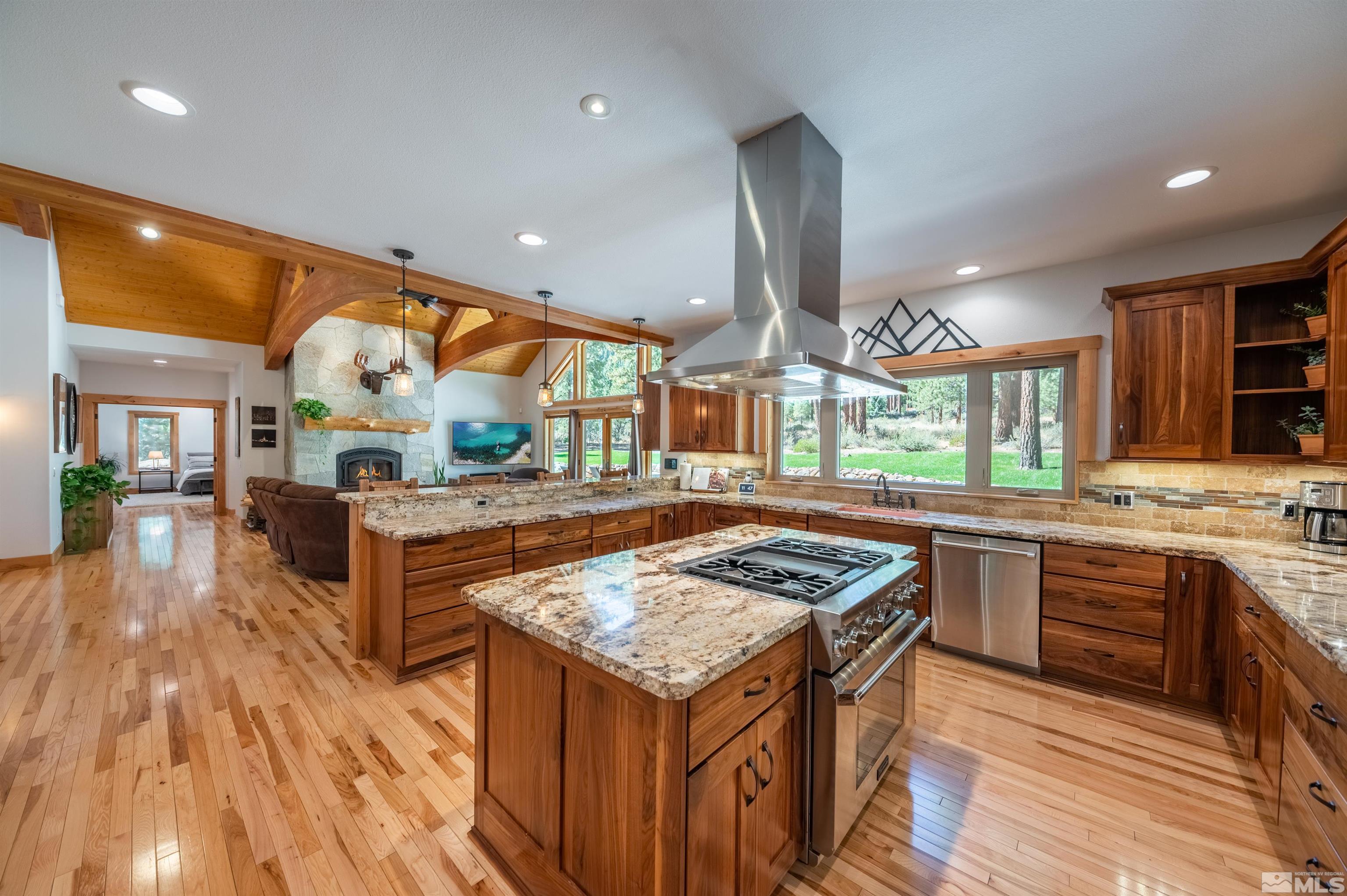 500 Yellow Pine Road Reno, NV 89511 - Photo 15 of 40 a kitchen with stainless steel appliances granite countertop a stove and a wooden floors
