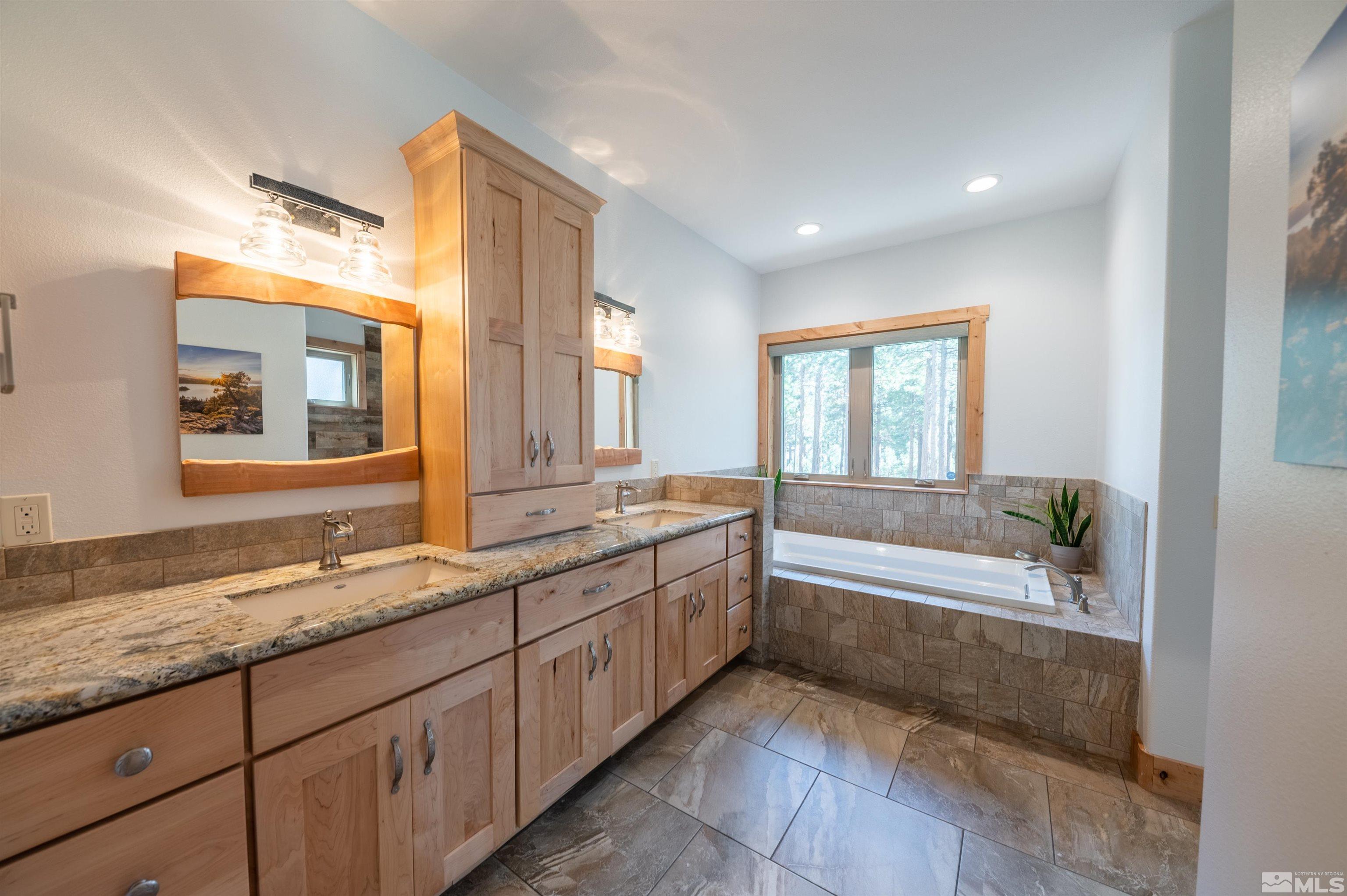 500 Yellow Pine Road Reno, NV 89511 - Photo 22 of 40 a spacious bathroom with a granite countertop tub sink and mirror