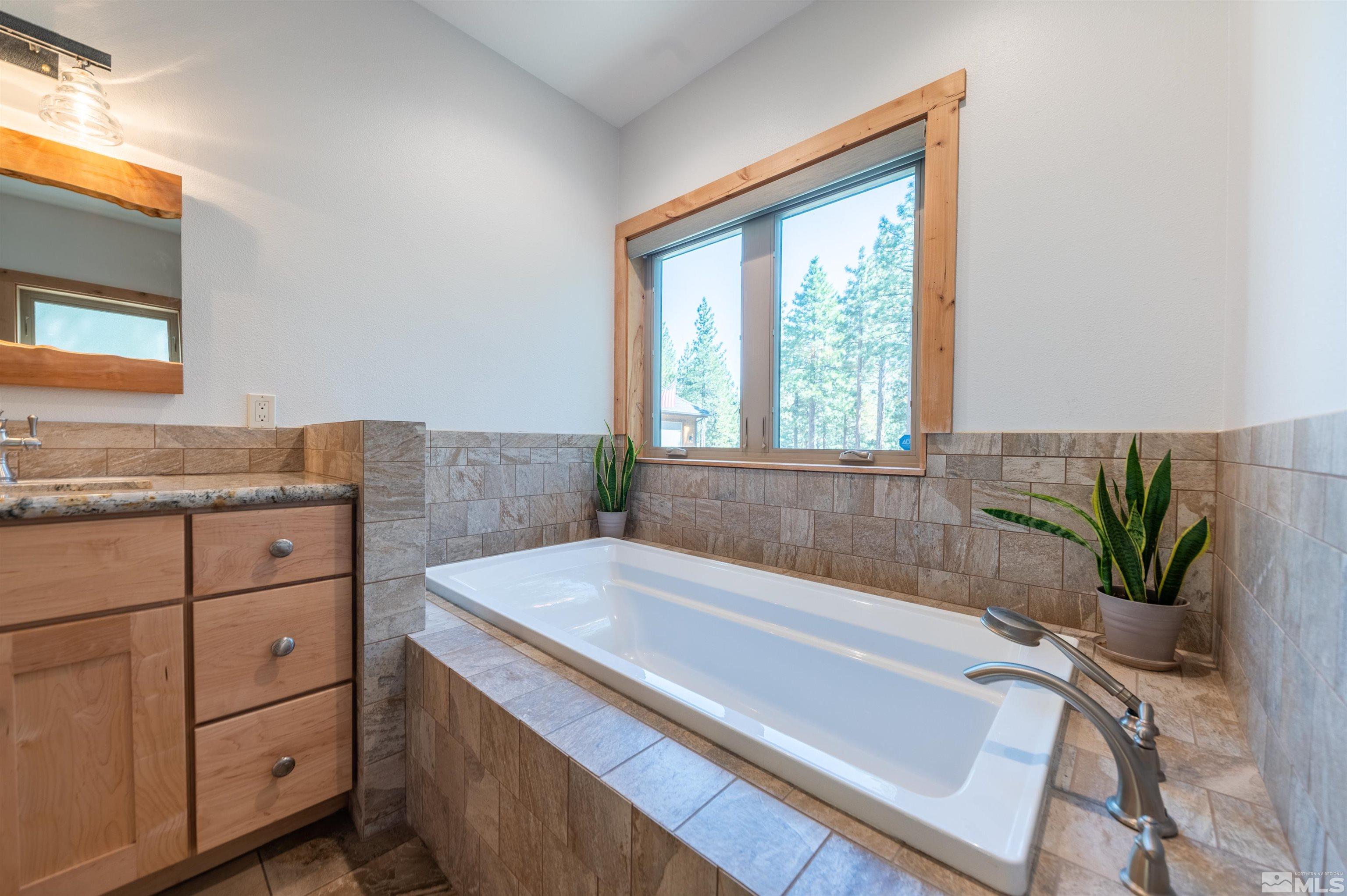 500 Yellow Pine Road Reno, NV 89511 - Photo 24 of 40 a bath tub sitting in a bathroom next to a window