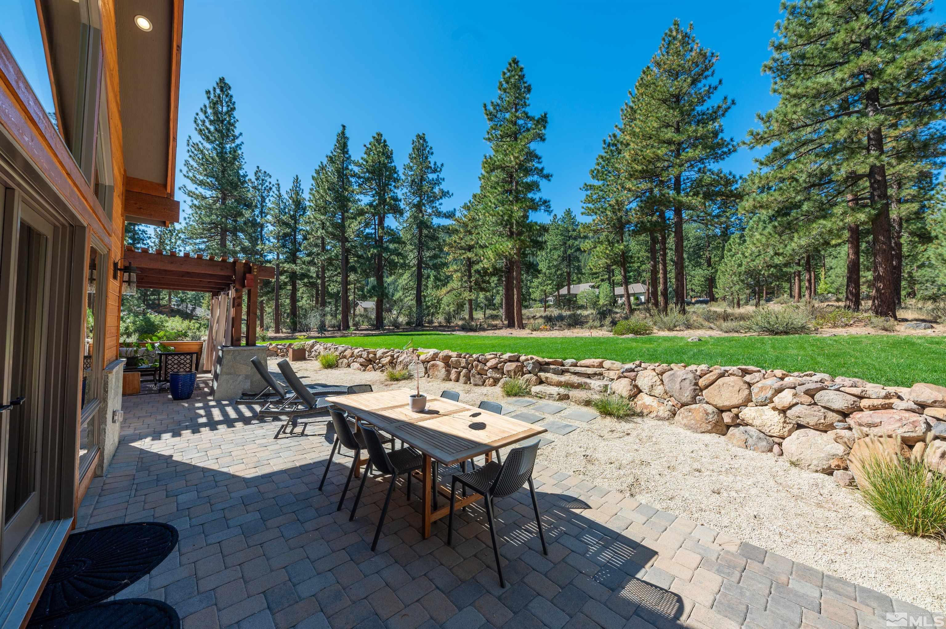 500 Yellow Pine Road Reno, NV 89511 - Photo 34 of 40 a view of a patio with table and chairs with wooden floor and fence
